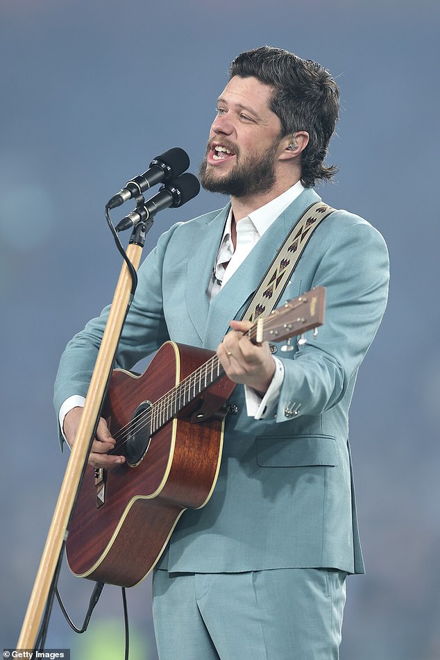 The 2024 Australian Idol winner delivered a stripped-down, guitar-driven performance of Advance Australia Fair to a sold-out crowd at Sydney's Accor Stadium.