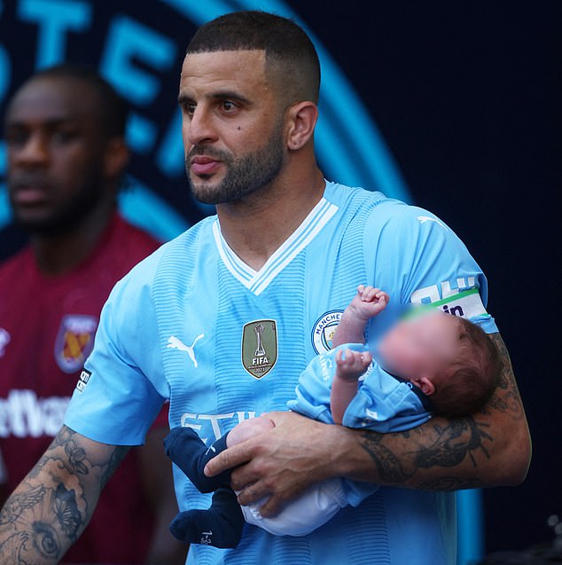 Manchester City footballer Walker with him and Annie's fourth child, Rezon, who was born in April.