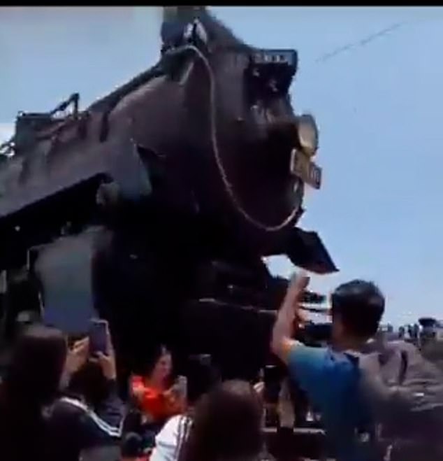 The video shows a huge train looming over the woman moments before hitting her