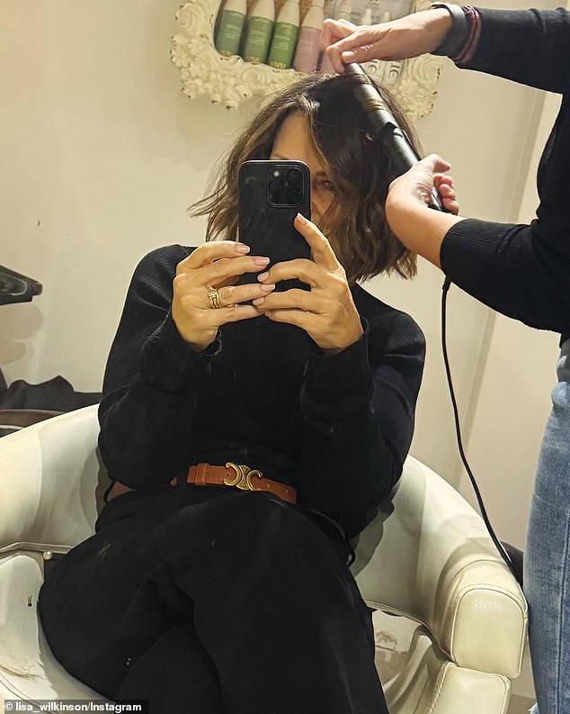 In an Instagram post, Lisa is seen taking a cheeky selfie at a salon while a stylist with 'magic hands' expertly curls her freshly cut, shaggy locks that are now shoulder-length.