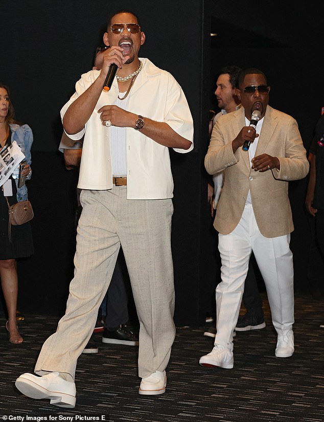 Will looked dapper in a pair of light gray linen wide-leg pants, which he paired with a white ribbed vest, a cream leather Cuban shirt, and matching loafers.