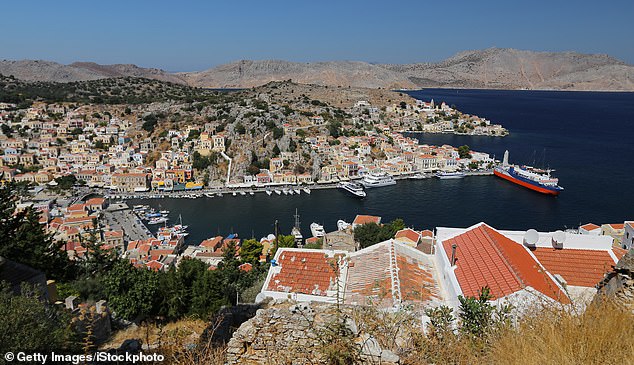 The Mail columnist is on holiday with his wife Clare on the Greek island of Symi (file image), off the coast of Rhodes.