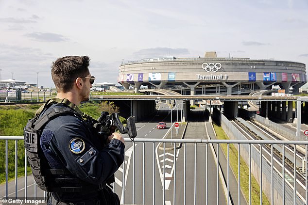 The explosion occurred on Monday in a hotel at Roissy-en-France airport, which was evacuated and later closed. Pictured: A French police officer stands guard at Charles de Gaulle airport during a recent opening ceremony ahead of the Olympic Games, which will be held in Paris this summer.