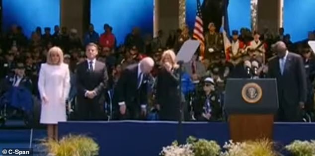 First lady Jill Biden covered her mouth and scratched under her nose as the president prepared to sit down.