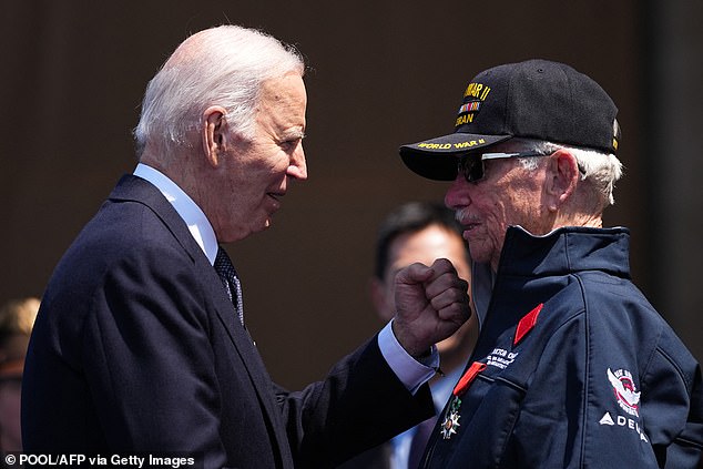 Biden greets World War II veteran Victor Chaney after he was presented with the Chevalier de la Legion d'Honneur (French Legion of Honor) during the ceremony commemorating the 80th anniversary of D-Day.