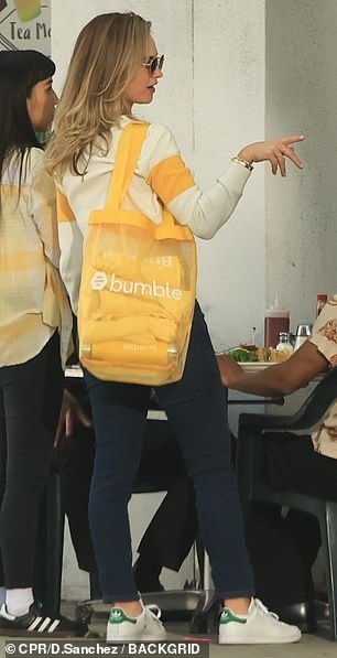 He donned a stylish white sweater with a yellow stripe across the chest with the Bumble logo in black.