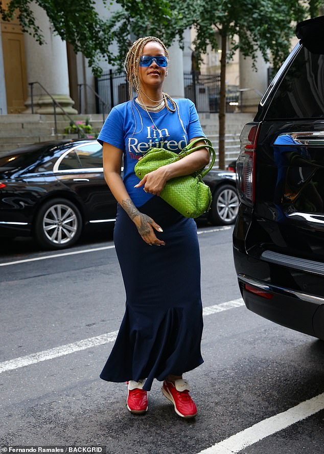 The nine-time Grammy winner, 36, jumped out of the backseat of a black SUV wearing a blue T-shirt that referred to her as 