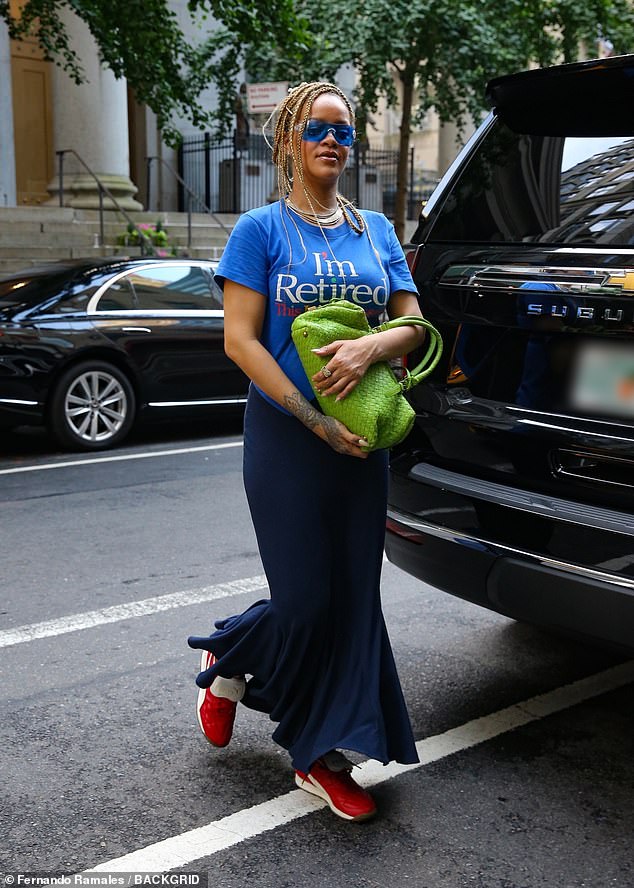 She paired the top with a navy blue mermaid skirt, red Puma sneakers, and a bright green Bottega Veneta bag.