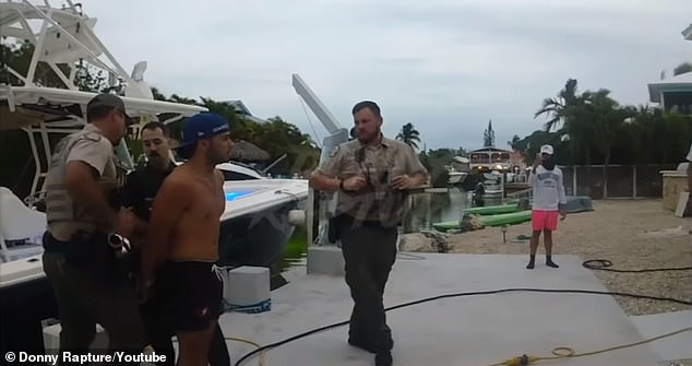 He was handcuffed after refusing to get off the boat and demanding officers 