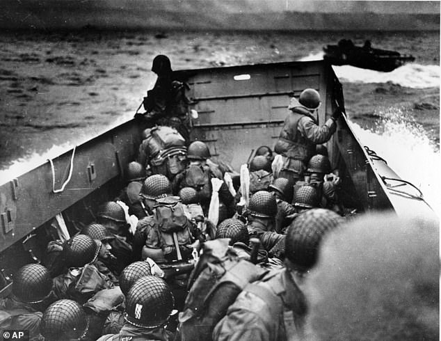 In this photo provided by the U.S. Coast Guard, a U.S. Coast Guard landing barge, packed with helmeted soldiers, approaches shore in Normandy, France, during initial landing operations ally, June 6, 1944.