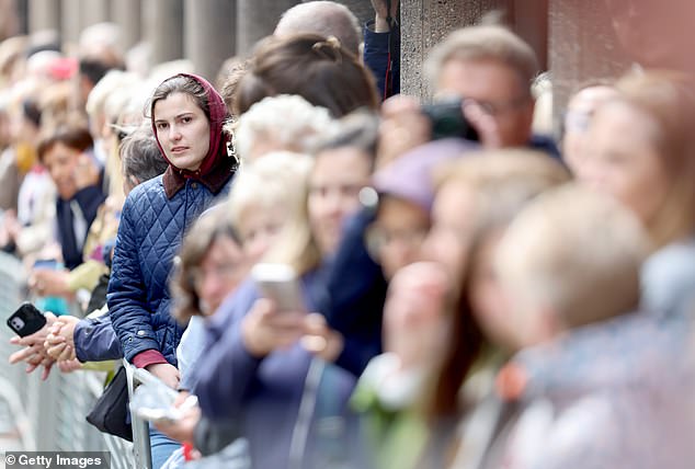 Well-wishers line the street ahead of today's wedding.