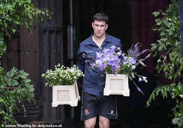 A fleet of vans delivered dozens of boxes of flowers to the cathedral