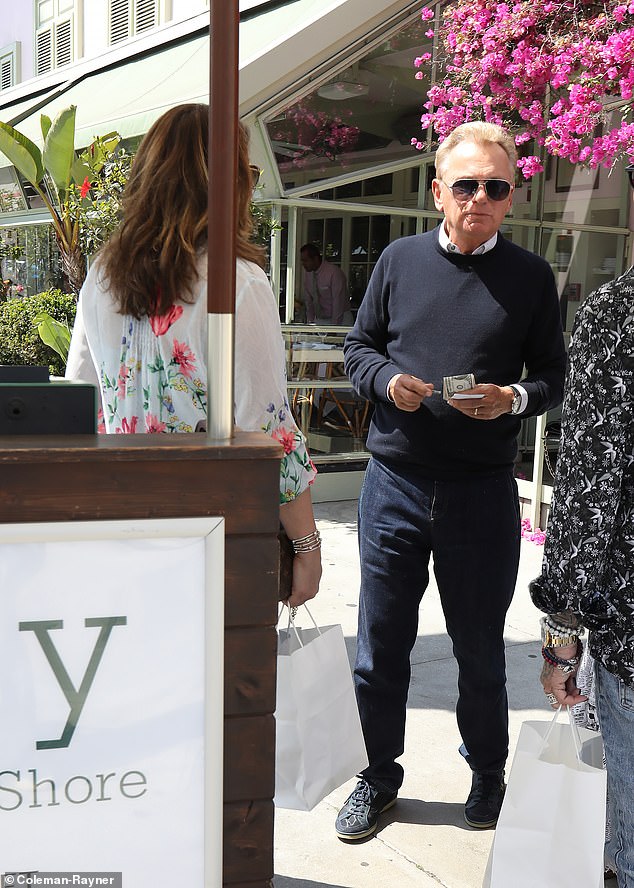 Sajak, known for his stylish style, looked dapper in a navy blue crew-neck sweater and jeans.