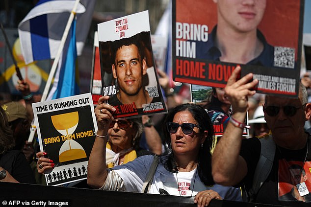 The mother of hostage Oz Daniel (centre) takes part in a protest campaign to return Israeli hostages in central London.