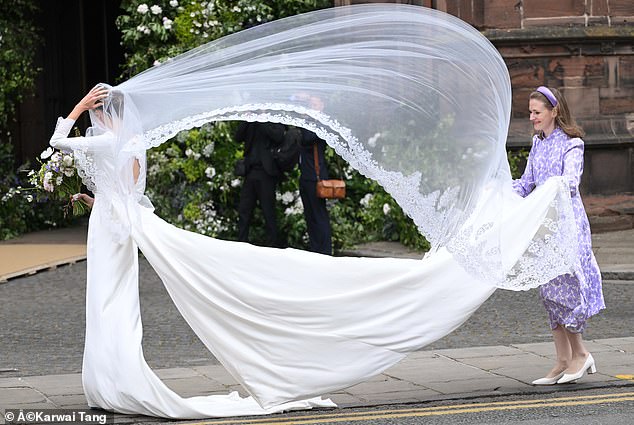 The bride's veil seemed to have a life of its own as it flew in the wind upon Olivia's arrival.