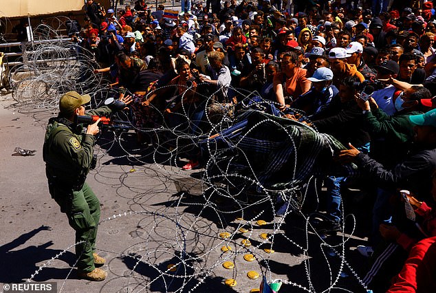 (Above) Migrants at the Paso del Norte international bridge to request asylum in the United States, seen from Ciudad Juárez, Mexico, on March 12, 2023.