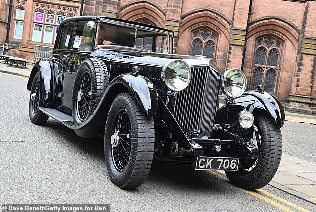 A 1930 Bentley Motors 8-litre awaits the chauffeur of the Duke of Westminster and Miss Henson from their wedding at Chester Cathedral