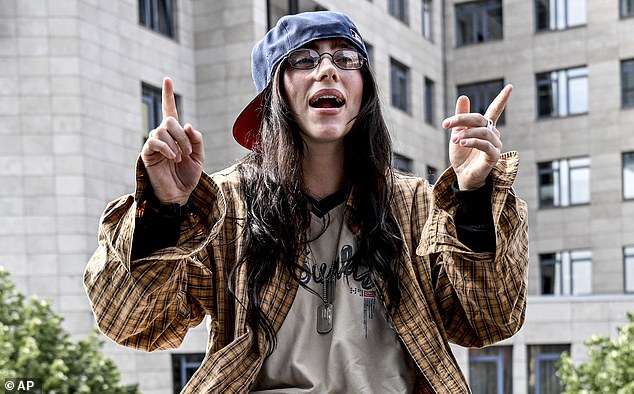 Billie, who will perform in Paris on June 11, appeared to be holding court when she was photographed sitting on the wall.