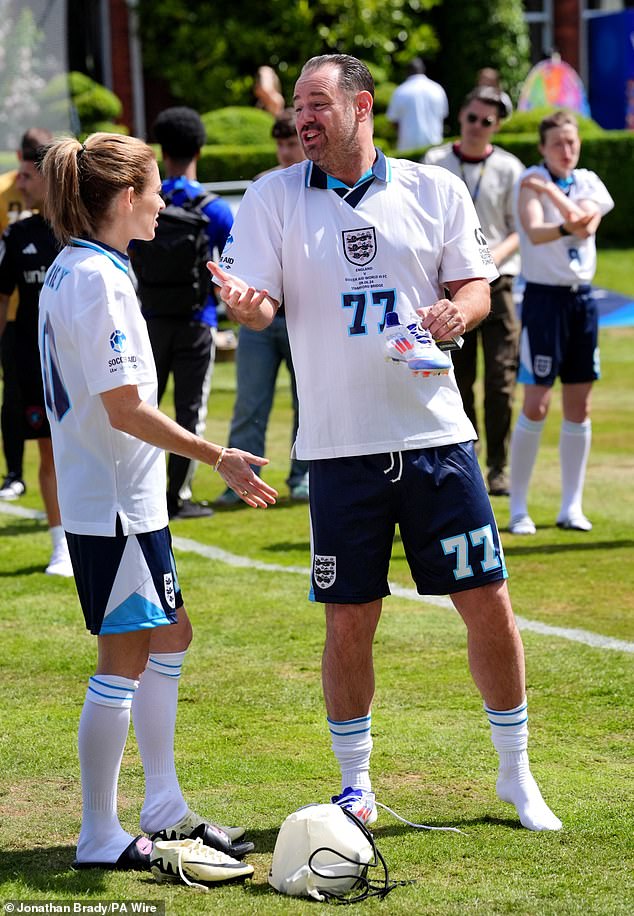 The actor appeared focused as he kicked the ball during a practice session, before catching former footballer Karen Carney.