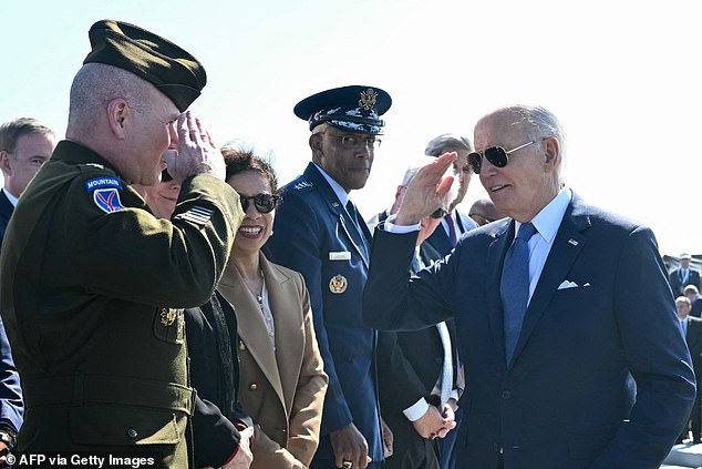 US President Joe Biden greets a US soldier in "Punta del Hoc" Cliff at Cricqueville-en-Bessin, northwestern France