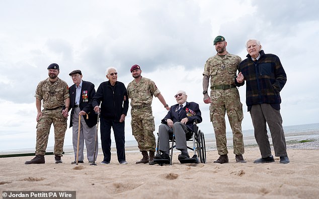 Sergeant Ben Beale, with Veterans Jack Mortimer, John Life, Corporal Aaron Stone, Veteran Donald Jones, Corporal Paul Squires and Veteran Peter Newton, as the veterans return to Sword Beach in Normandy, France, after landing there the day D.