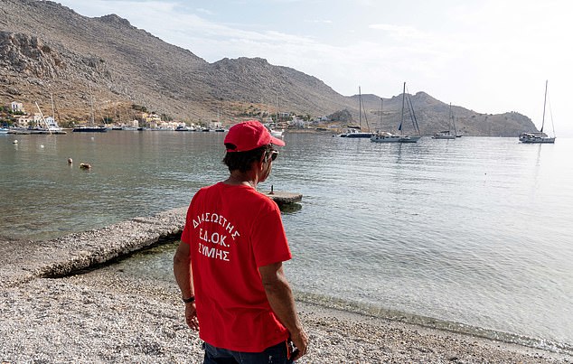 Workers arrive to continue the search at Pedi Beach on Symi Island on June 7.