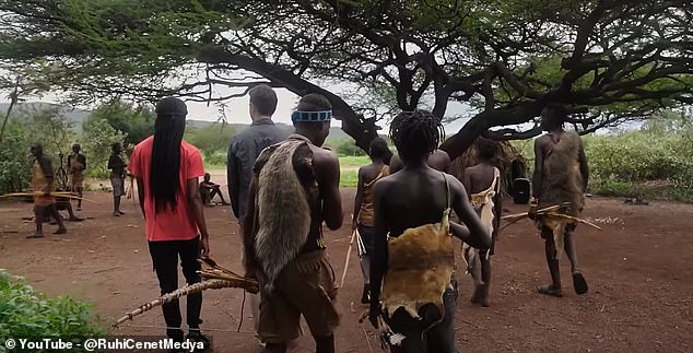 As a form of camouflage, men wear baboon skins and other animal skins on their heads and around their torsos.