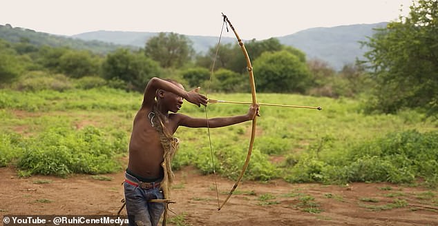 In another scene in the documentary, younger members of the tribe are seen honing their bow and arrow skills.