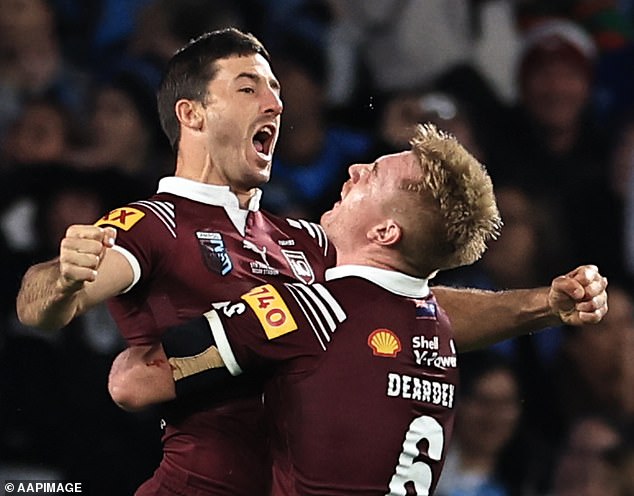 Hunt celebrates with Queensland teammate Tom Dearden after scoring a try against the New South Wales Blues on Wednesday night.