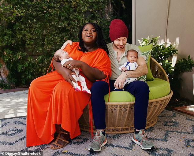 In the photos, the American Horror Story alum wore a chic orange dress while holding baby Cooper, who was adorable in a blue and white striped onesie.