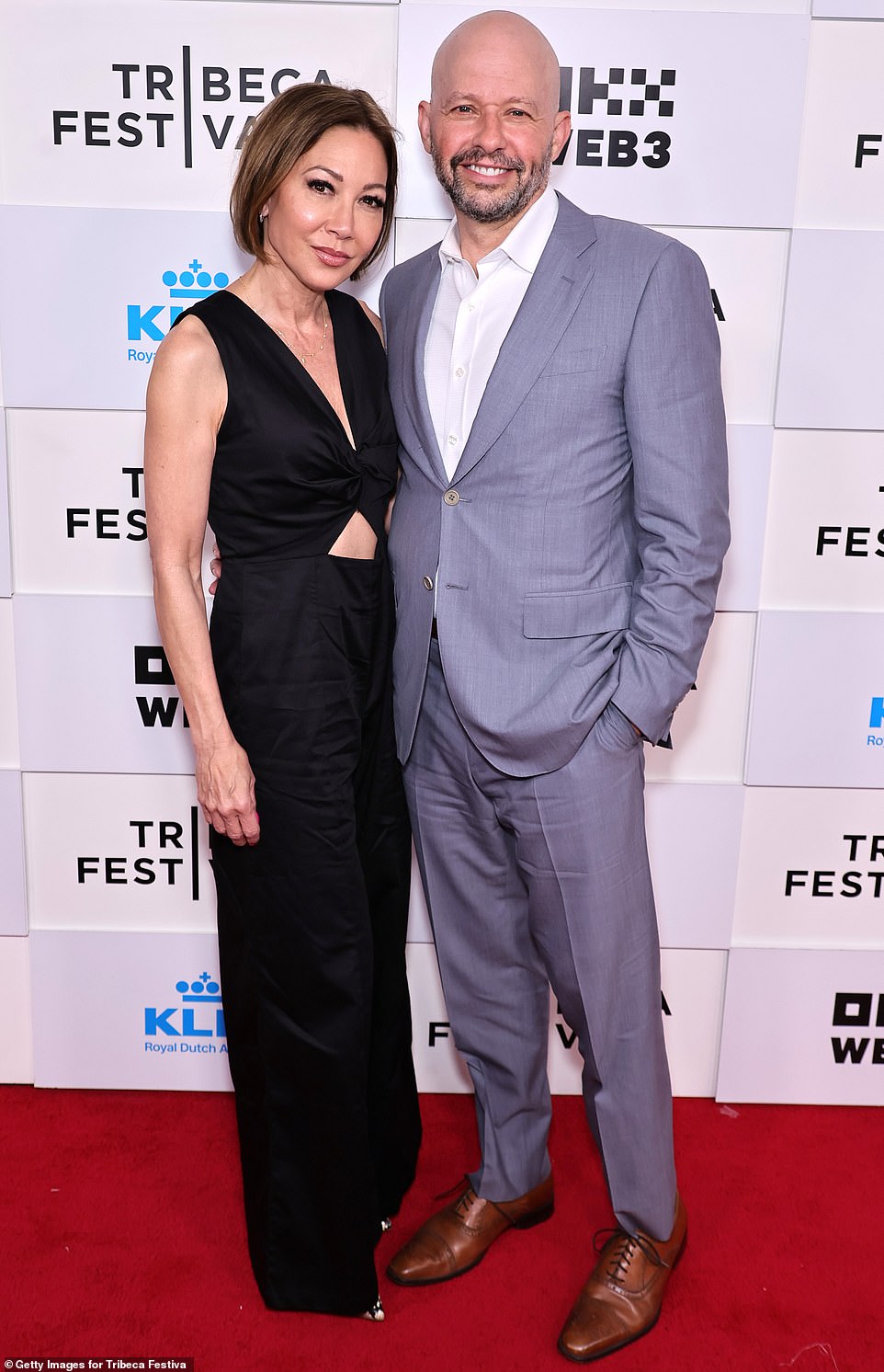 Jon looked dapper at the premiere in a silver suit without a tie, as he posed alongside his black-clad wife, Lisa Joyner.