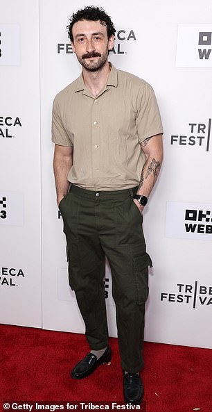 Adam Weiss donned a tan short-sleeved button-down shirt, which he tucked into a pair of green cargo pants with black loafers.