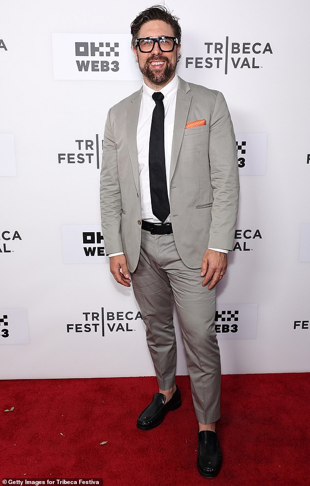 Nathan Ruyle looked dapper in a tailored gray suit with a black tie and matching belt and shoes.