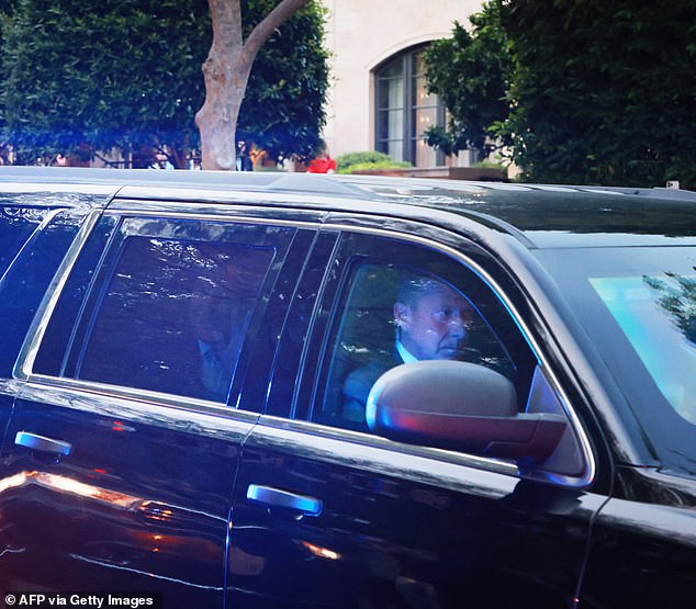 Trump could be seen waving to his supporters gathered on the side of the road.