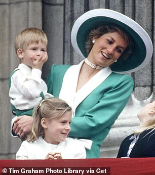 Diana on the balcony of Buckingham Palace holding a young Prince Harry in 1988