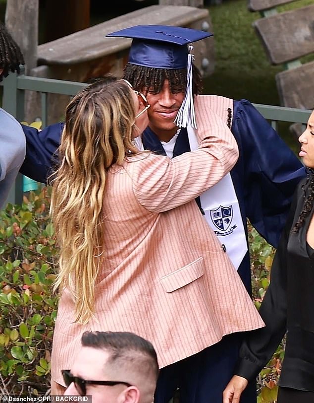 Heidi looked every inch the proud mother as she gave Henry a kiss on the cheek.