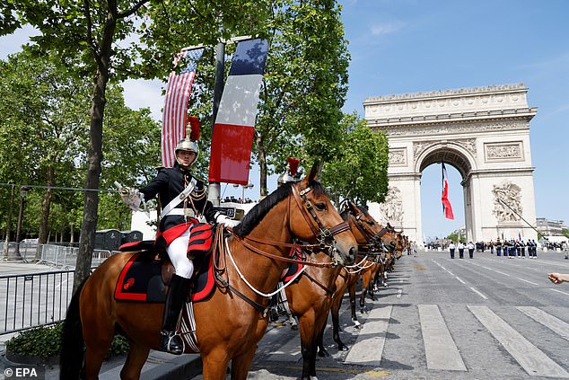 The French Republican Guard stands in front of the Arc de Triomphe before a welcoming ceremony with the president of France and the president of the United States, in Paris.