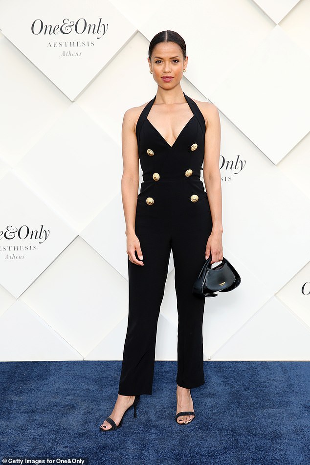 Gugu Mbatha-Raw put on a busty display in a plunging black jumpsuit as she posed on the event's blue carpet.