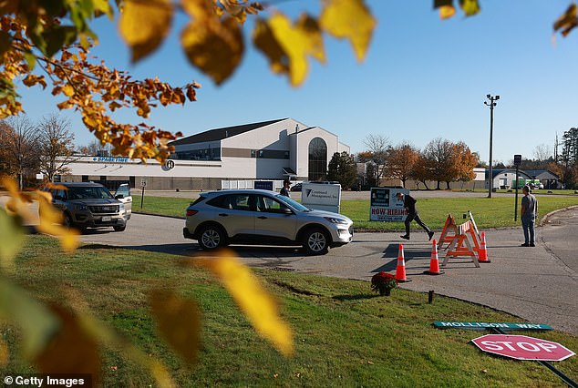 A law enforcement officer mans a checkpoint next to Sparetime Recreation, one of two locations where the mass shooter targeted.