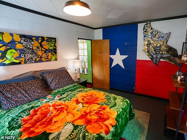 A huge mural of the Texas flag adorns a bedroom wall, paired with bold linens.