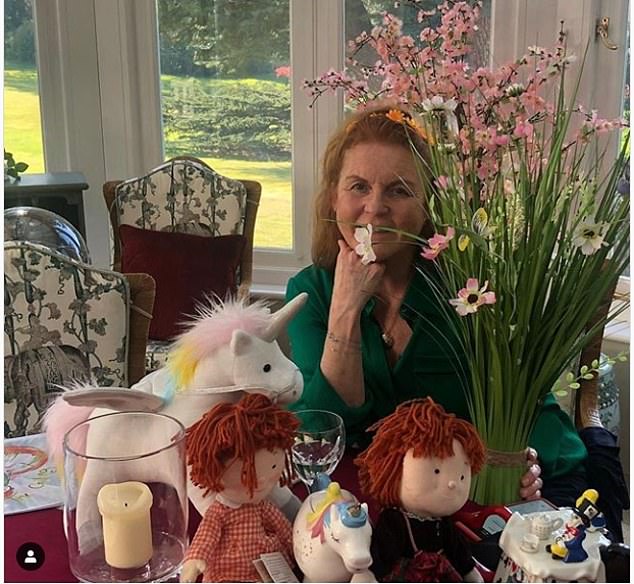 Sarah Ferguson poses inside the Royal Lodge. You can see the beautiful gardens behind it.