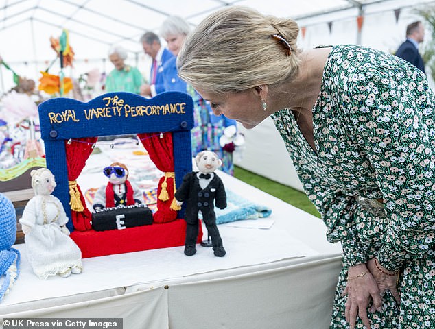 The knitted display was created by residents of Brinsworth House in Twickenham (pictured: Sophie looks at knitted figures of her and Prince Edward)