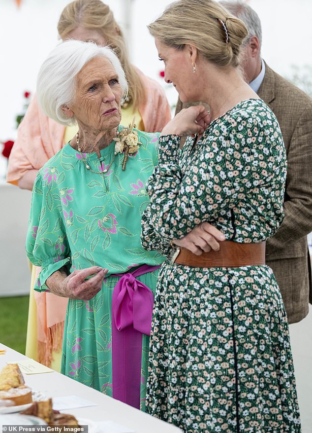 The two women appeared to be deep in conversation as they examined some of the baked goods on offer.