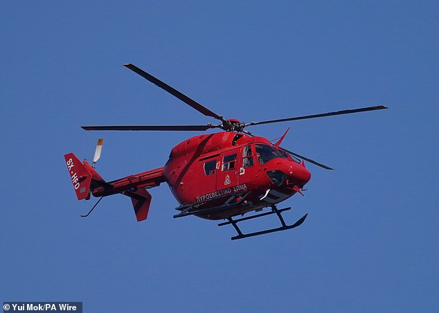 A rescue helicopter joined the search yesterday, seen here flying over Pedi