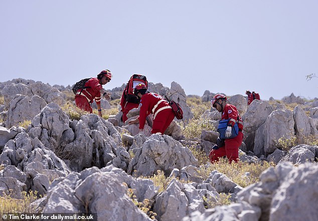 It is feared that Michael Mosley may have become disoriented in the heat and wandered off the trail, although this seems unlikely as it is clearly marked. In the photo: Rescuers on the road.