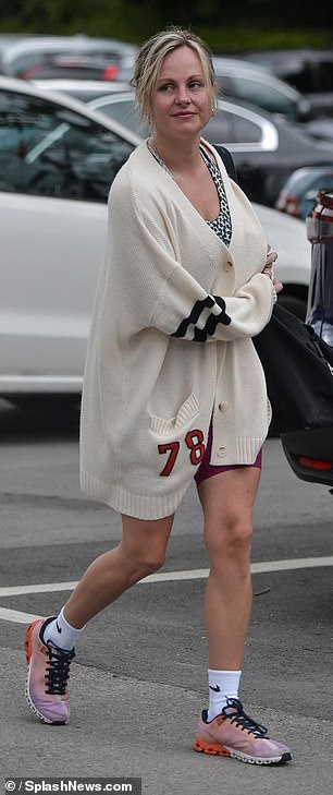 She completed the look with pastel-colored sneakers and white Nike socks, and accessorized with a pair of gold earrings.