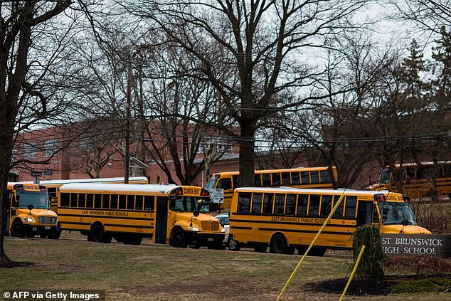 School buses leave the East Brunswick High School campus after the school day on February 22, 2018.