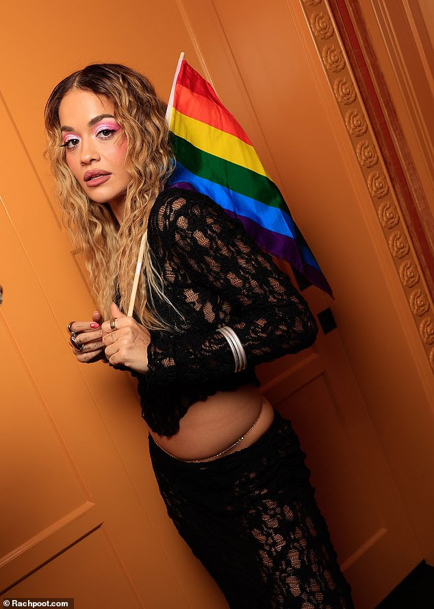 Rita posed with the rainbow flag while celebrating Pride.