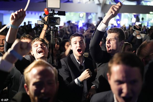 Supporters of the French far-right national rally react at the party headquarters on election night after French President Emanuel Macron announced he is dissolving the National Assembly.