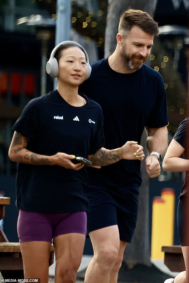 Spending some quality time with the sex book author (left) in Sydney, Todd and his new love got active with a group of runners and went jogging through the streets.